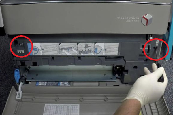 unscrewing the screws inside the printer